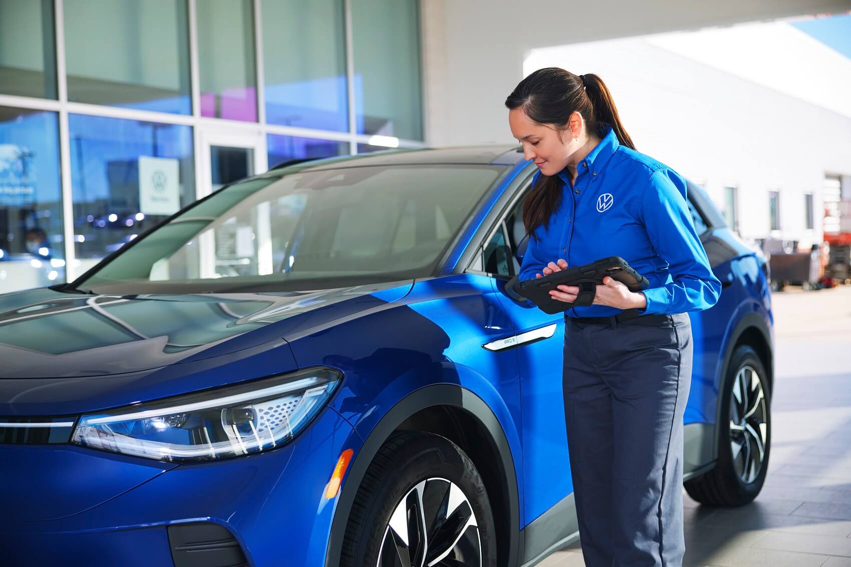Volkswagen Service Technician Inspecting a Used Car